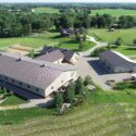 Aerial view with equine facility in front and home further back