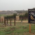 View of property on misty day, with large Moonstone Farm sign on right.