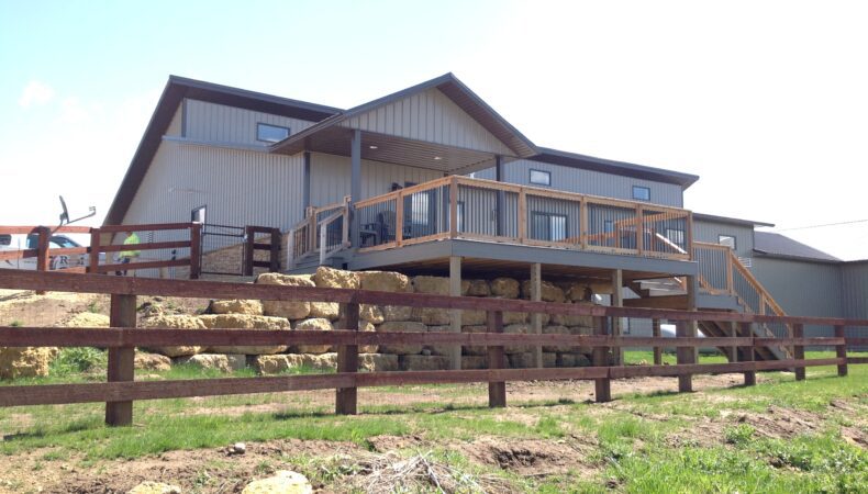 Post-frame home with view of large deck.