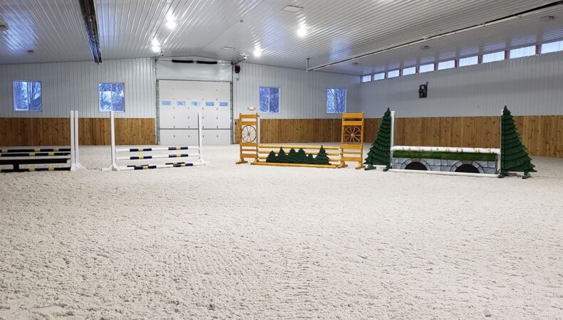 Riding area with several jumping equipment set up in a row.