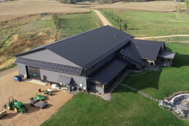 Large post-frame residential home - gray siding with gray roof.