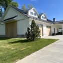 View of garage with wood barn doors covering large glass garage doors.
