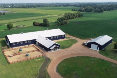 22-817 Aerial view of property with equestrian barn.