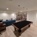 Game room with pool table and large bookshelves