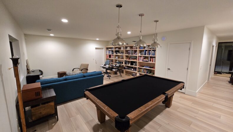 Game room with pool table and large bookshelves