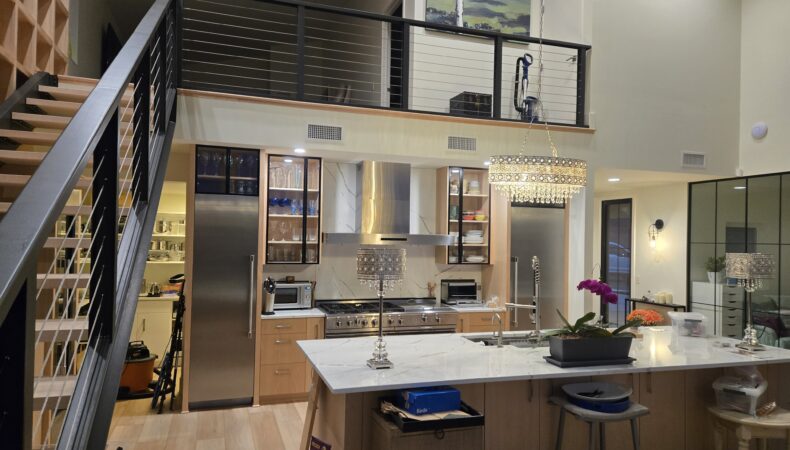 View of full kitchen with mezzanine area above