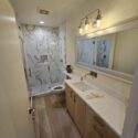 Bathroom with marble shower wall