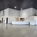 View of front desk and stairs from showroom floor.