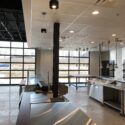 View of kitchen area with large clear garage doors letting natural light in
