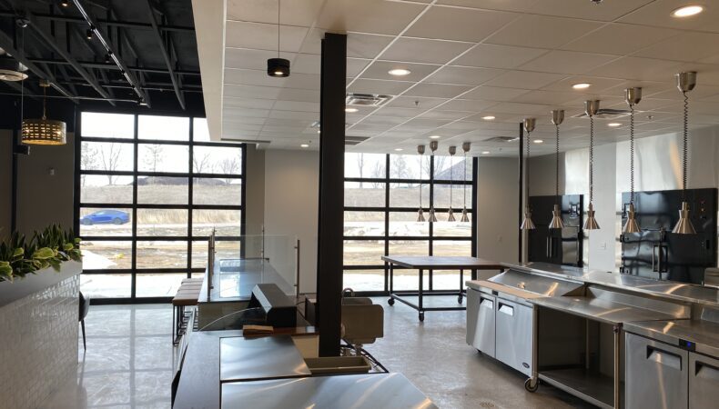View of kitchen area with large clear garage doors letting natural light in