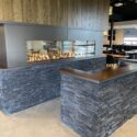 Entrance of restaurant with fireplace feature behind desk