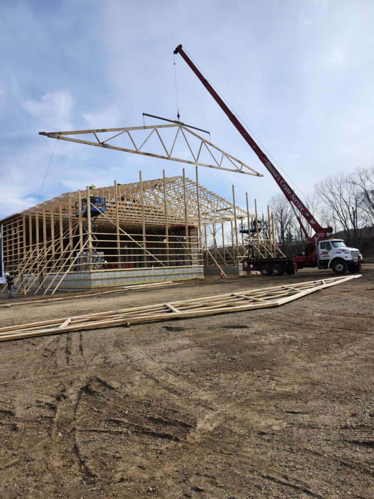 Frame being placed in new building.