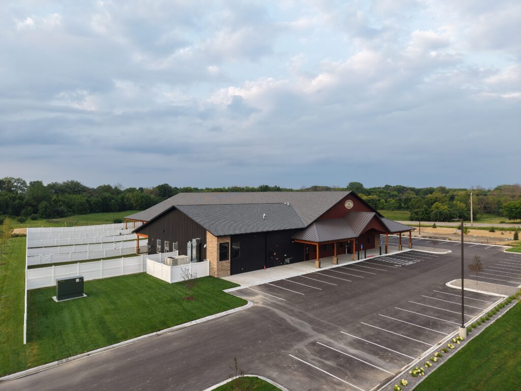Front of Red Barn Pet Resort with fenced in area to the left.