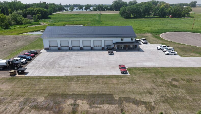 View of long garage space with several garage doors