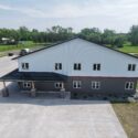 Right side of building: bottom half dark gray, top half white siding