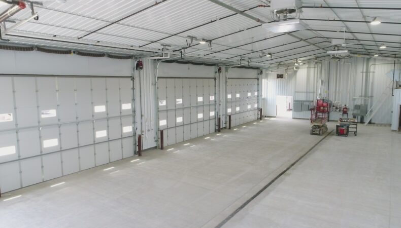 3 large garage doors from interior of truck station