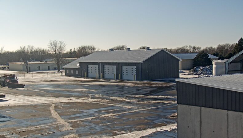 View of large 3 stall garage from parking lot.