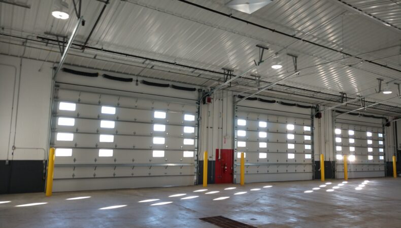 3 large garage doors from interior of vehicle garage.