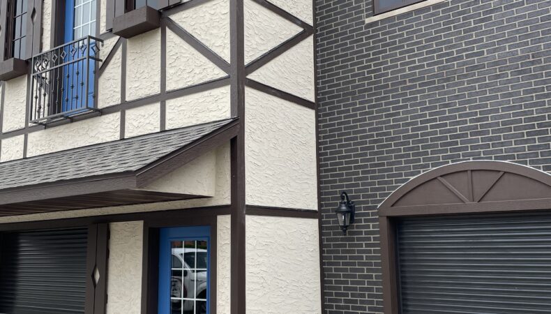 Side view of tan building with blue doors