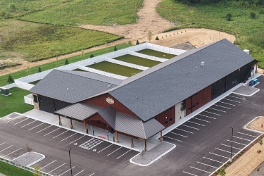 Aerial view of Red Barn property with fenced play areas in back.