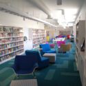 View of library with large colorful chairs in middle.