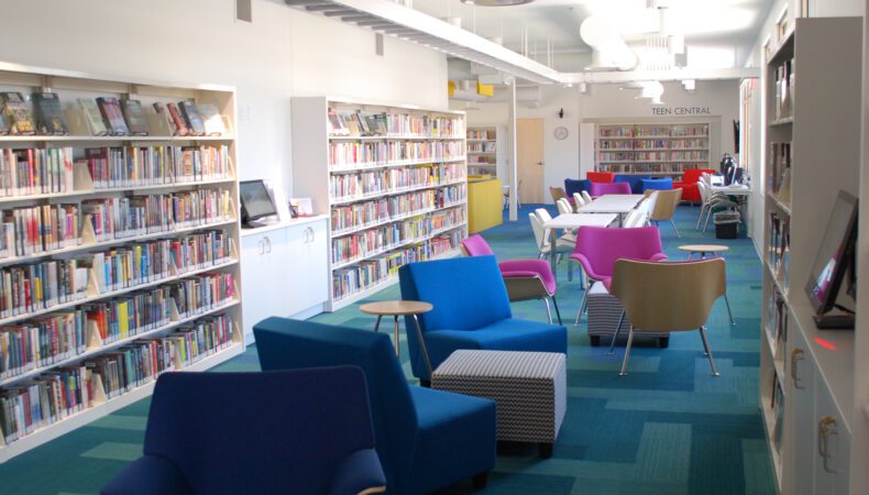 View of library with large colorful chairs in middle.