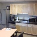 Break room with large fridge, dishwasher and microwave.