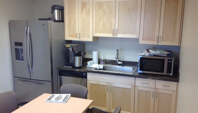 Break room with large fridge, dishwasher and microwave.